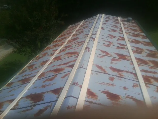 Rusted metal roof panels with new wood purlins before replacement — Storm Damage Roof Repair in Spotswood by Roofing Brothers