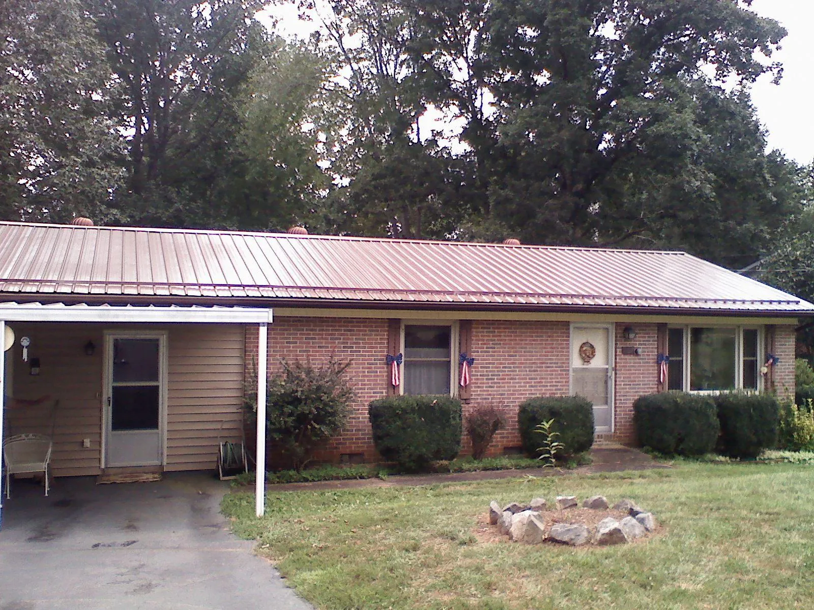 Bronze metal roof and carport on a brick ranch home — Roof Repair work by our crew in Spotswood