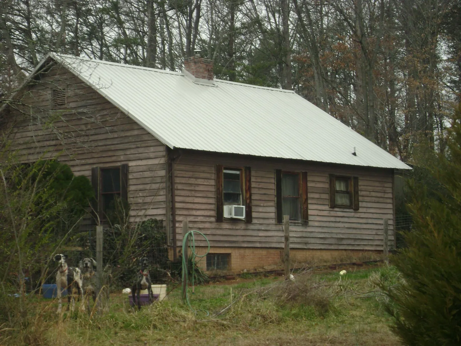 White metal roof on an old wood sided farmhouse, from a Metal Roof Installation job in Spotswood